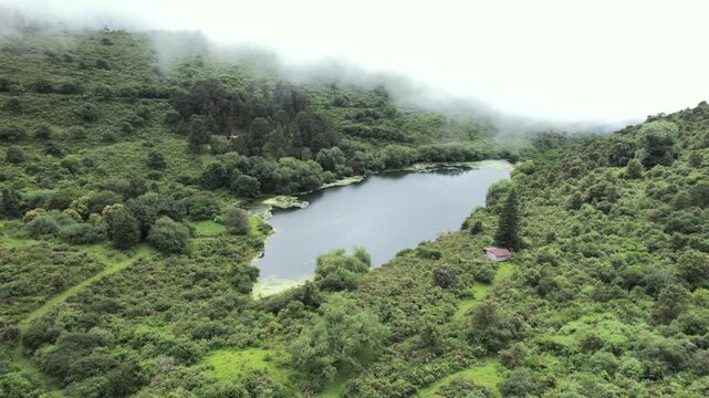 4K drone aerial view of Yala, Jujuy, Argentina. Misty mountain lakes surrounded by lush Yungas forests and dense green vegetation, creating a spectacular subtropical Andean landscape.