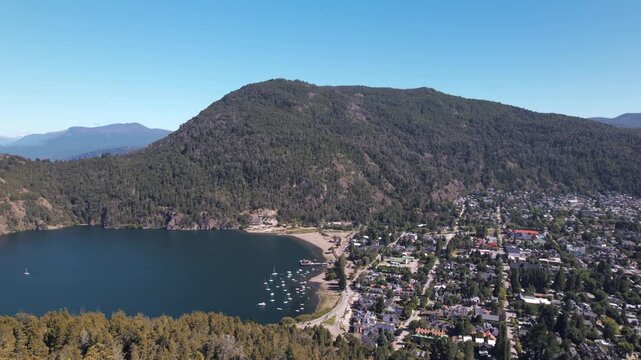 4K drone aerial view from Mirador Arrayanes overlooking San Mart&iacute;n de los Andes, Lake L&aacute;car and the surrounding green mountains in Patagonia, Argentina.