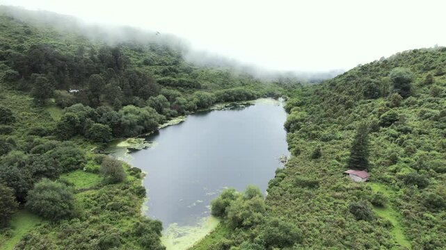4K drone aerial view of Yala, Jujuy, Argentina. Misty mountain lakes surrounded by lush Yungas forests and dense green vegetation, creating a spectacular subtropical Andean landscape.
