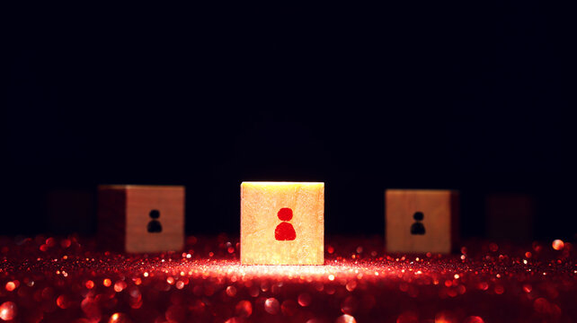 wooden cubes with people figures on dark background, human resources, leadership and management concept