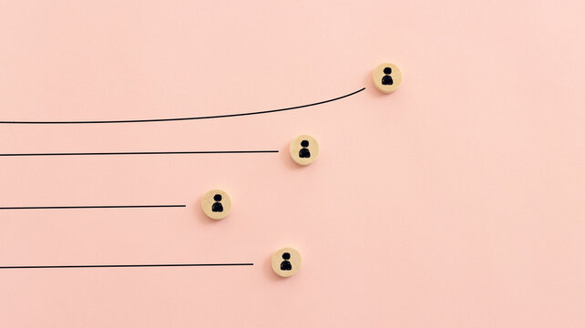 Wooden cubes with people icons over pastel background, human resources and management concept