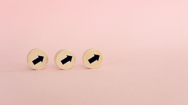 Top view image of arrows on pink paper background