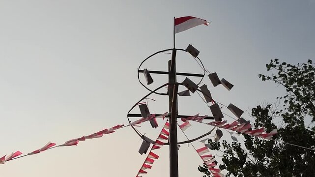 Close-up of a greased pole being prepared for Panjat Pinang, a traditional Indonesian game celebrating Independence Day and local cultural heritage.
