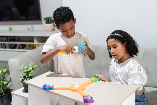 Children playing board game together at home