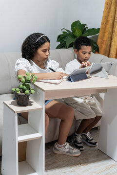 Children learning at home using digital tablets and notebook