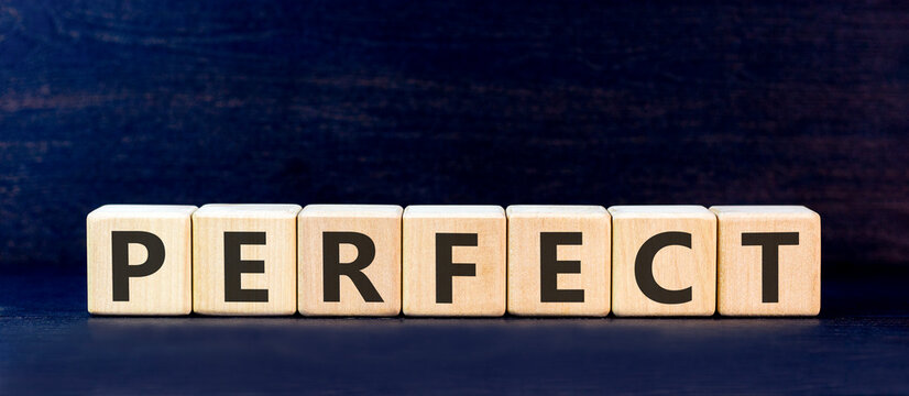 Perfect word symbol. Concept word Perfect on beautiful wooden blocks. Beautiful black table black background. Business perfect word concept. Copy space.
