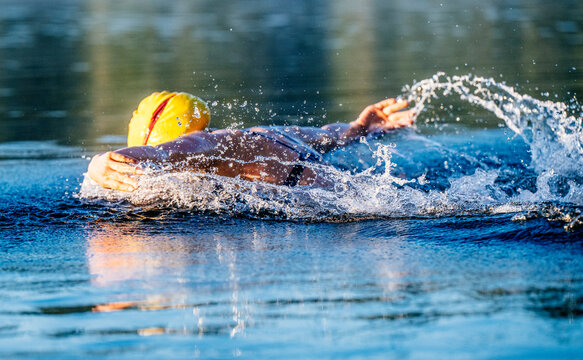 White swimmer performing backstroke stroke in open water