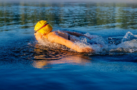 White swimmer performing freestyle stroke in open water