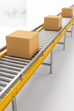 Three cardboard boxes moving up a roller conveyor against a white background