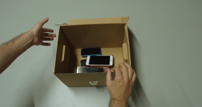 Discarding Old Smartphones into Recycling Box