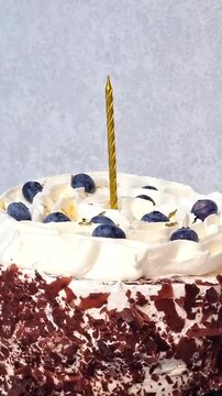 birthday white cake with candle and bluberry
