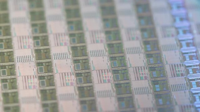 wafer silicon monocrystalline  with microchips after photolithography etching manufacturing reflecting different colors used in fabrication of electronic integrated circuits.