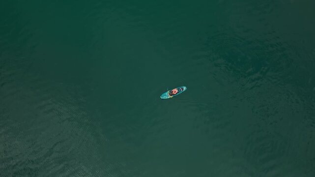 Standup Paddleboarding At Lake Achensee With Calm Waters In Austria. - aerial shot