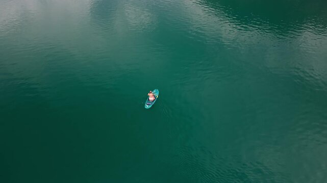 Woman Standup Paddleboarding In Achensee With Mountain Views In Austria. - aerial shot