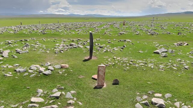 Asian deer stone monument bears ritual symbols on an ancient burial stele in open steppe.