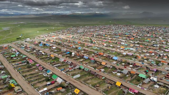 Urban housing districts in Mongolia form a colorful city grid of roofs streets and blocks.