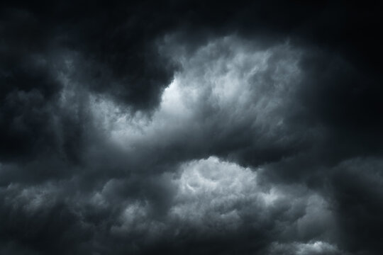 Against a backdrop of dark storm clouds. A dramatic, gloomy sky before the storm.