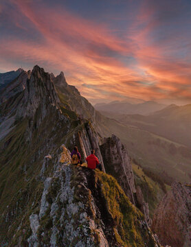 Stunning sunset view from Schafler ridge in Appenzell Switzerland with hikers enjoying nature