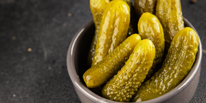 Gherkins pickled cucumbers vegetable appetizer healthy eating tasty snack fresh, gourmet, rustic food background on the table top view copy space