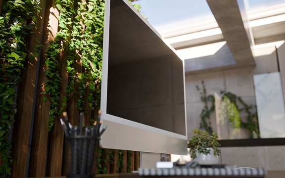 Computer All in One Blank Screen in Modern Home Office Workspace with Vertical Garden and Concrete Walls