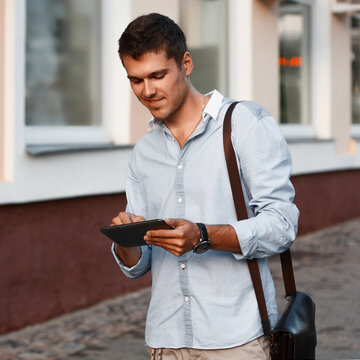 Happy young male executive using digital tablet.