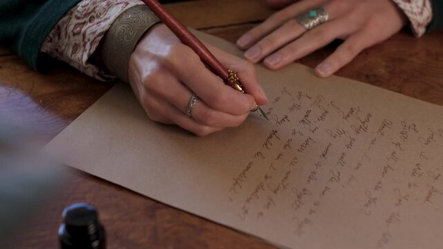 An antique young woman in a resurgent dress, sitting at the table and writing a letter with a vintage pen on an old paper sheet of parchment. The girl is writing a letter in handwritten script. 
