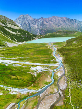 Mountain valley with river road, green hills, wilderness travel and hiking destination