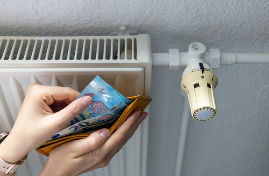 Counting euro cash money to pay for expensive winter heating bills