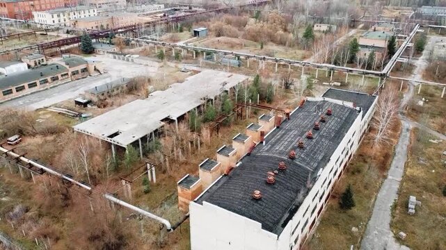 An old, abandoned building set against the backdrop of autumn nature.
