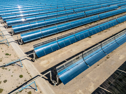 aerial view of blue parabolic trough solar thermal power plant