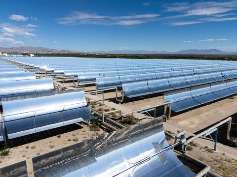rows of parabolic trough solar thermal power plant in desert