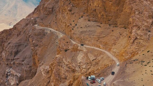 Scenic aerial drone shot of a winding himalayan road in Hikkim, spiti valley. The rugged mountain landscape and breathtaking views.