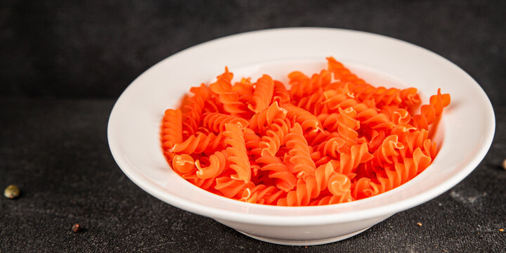 Red lentil pasta fusilli gluten-free fresh pasta healthy eating tasty snack gourmet, rustic food background on the table top view copy space  vegetarian and vegan food