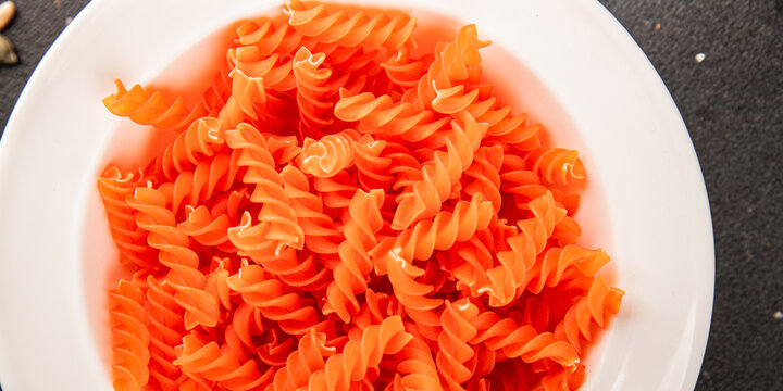 Red lentil pasta fusilli gluten-free fresh pasta healthy eating tasty snack gourmet, rustic food background on the table top view copy space  vegetarian and vegan food