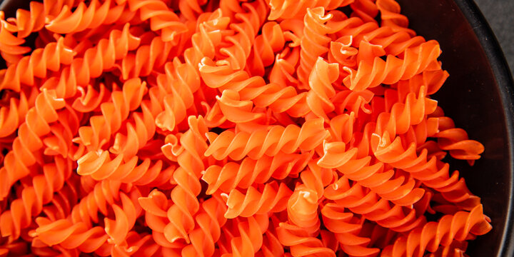 Red lentil pasta fusilli gluten-free fresh pasta healthy eating tasty snack gourmet, rustic food background on the table top view copy space  vegetarian and vegan food