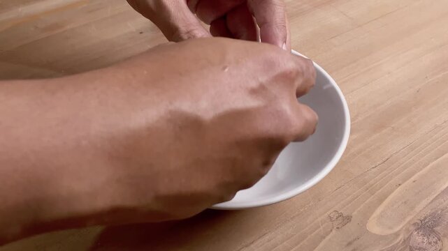 Close up Hand cracked an egg into the bowl for cooking breakfast