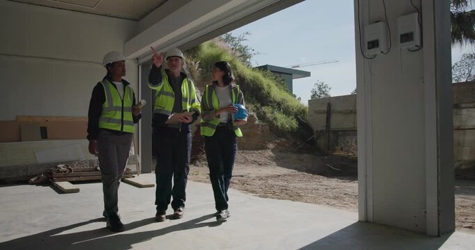 Construction, team and clipboard for building inspection, safety audit or project progress review. People, architect and electrician with site visit for remodeling quality, punch list and compliance