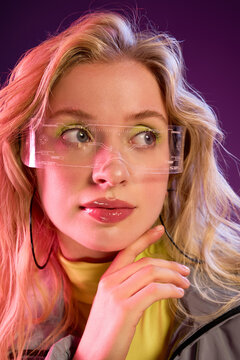 Stylish young woman with blonde hair in trendy accessories and vibrant colors