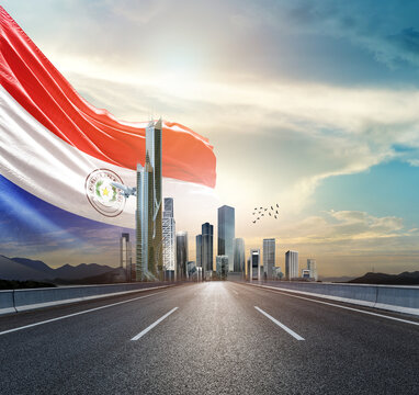 Paraguay national flag waving behind the cityscape. Paraguay national flag for independence day.
