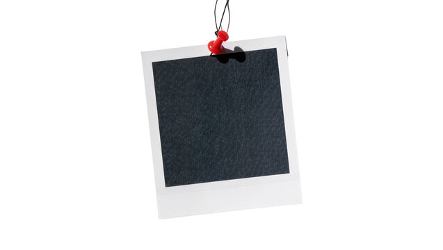 Blank instant photo frame with dark textured surface pinned with red thumbtack, isolated on transparent background