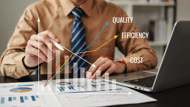 Businessman analyzing upward trend graphs for quality efficiency and cost reduction at desk during daylight
