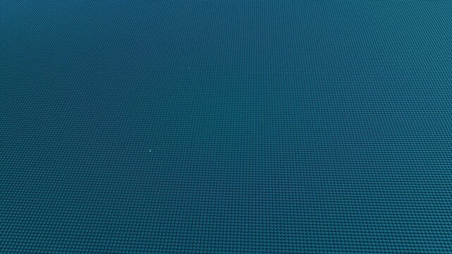 Dynamic teal micro-bead surface pattern flowing seamlessly, creating a modern digital technology background loop