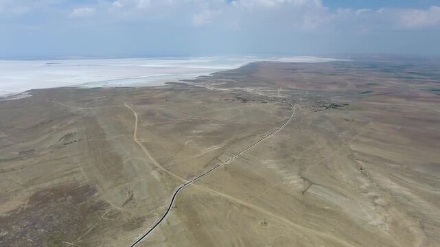 Aerial saltworks reveal evaporation ponds, levees, roads, and industrial basins beside Tuz Golu.