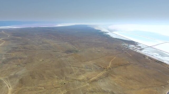 Aerial saltworks reveal evaporation ponds, levees, roads, and industrial basins beside Tuz Golu.
