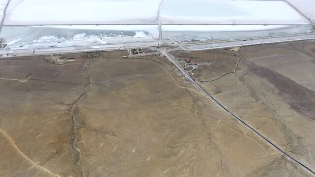 Aerial saltworks reveal evaporation ponds, levees, roads, and industrial basins beside Tuz Golu.