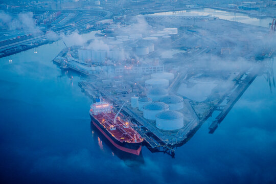 Oil tanker docked at fuel storage terminal in a beach