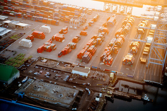 Cargo containers stacked at a major container yard during sunset