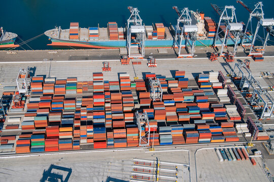 Shipping containers and cargo ship at a container terminal in a beach