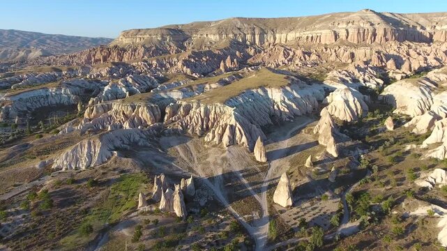 Aerial views sweep across Cappadocia fairy chimneys, valleys, and eroded tuff landscapes.