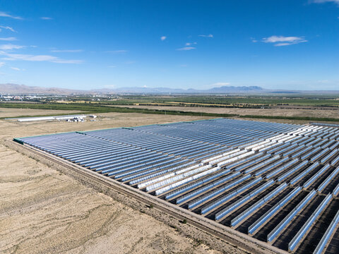 Solar thermal power plant with parabolic trough collectors in desert landscape
